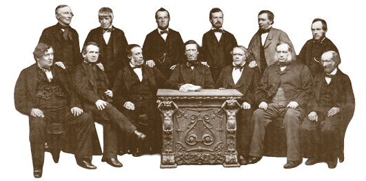 A group of men in suits sitting in front of a table. Description generated by AI