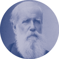 A man with a long beard and mustache sitting in a chair. Description generated by AI